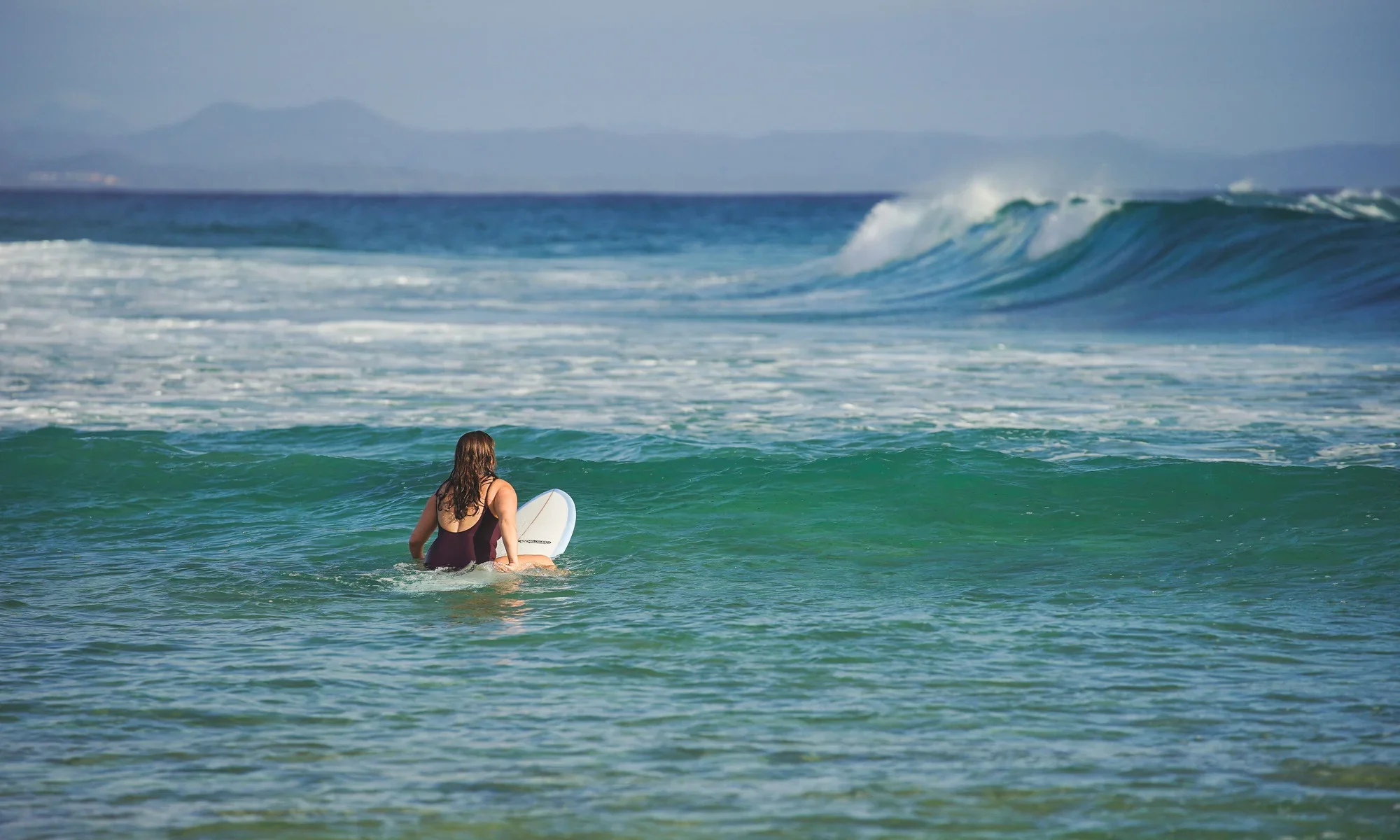 Michelle Williams surfing at Byron Bay