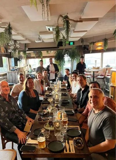 Local leaders gathered around a shared dinner table at a Remix event.
