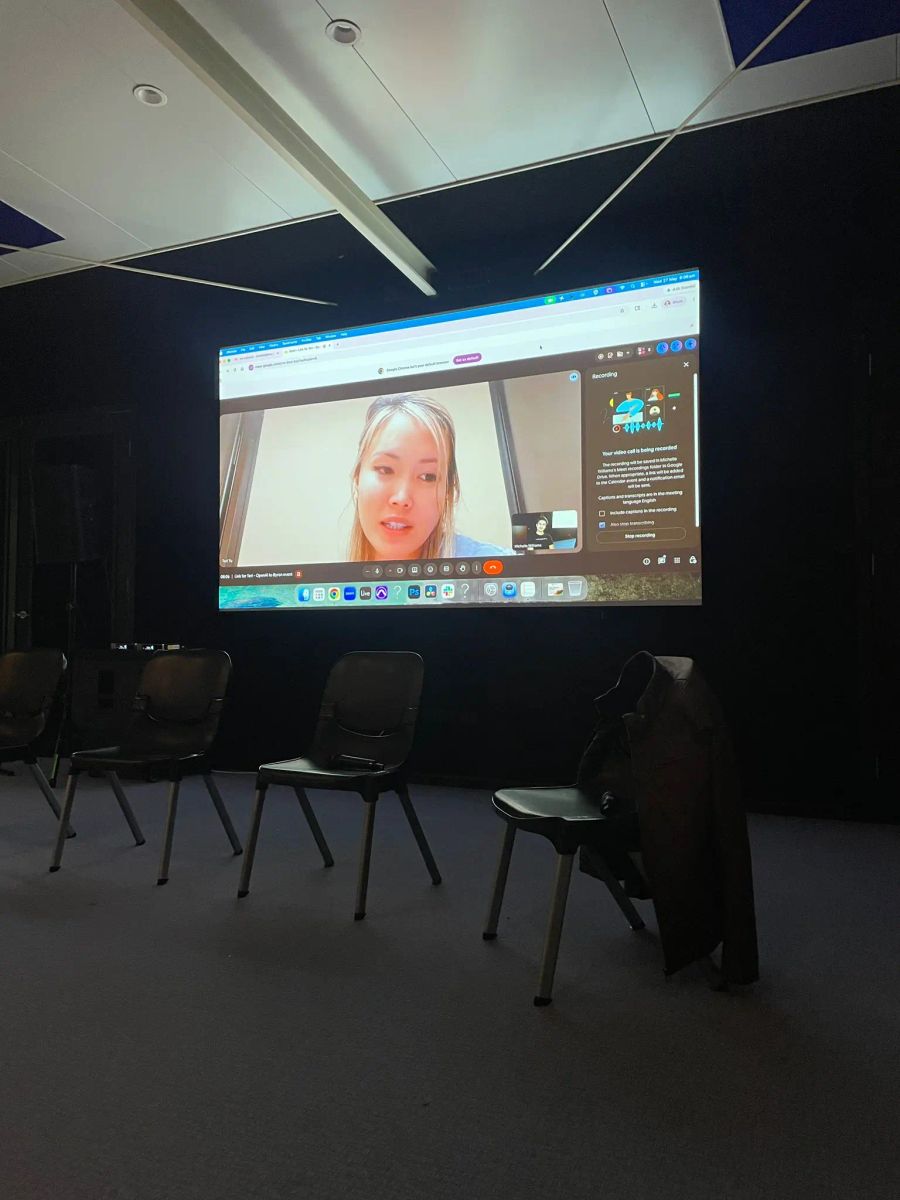 OpenAI speaker Teri Yu streamed live onto a large screen for The Remix audience in Byron.